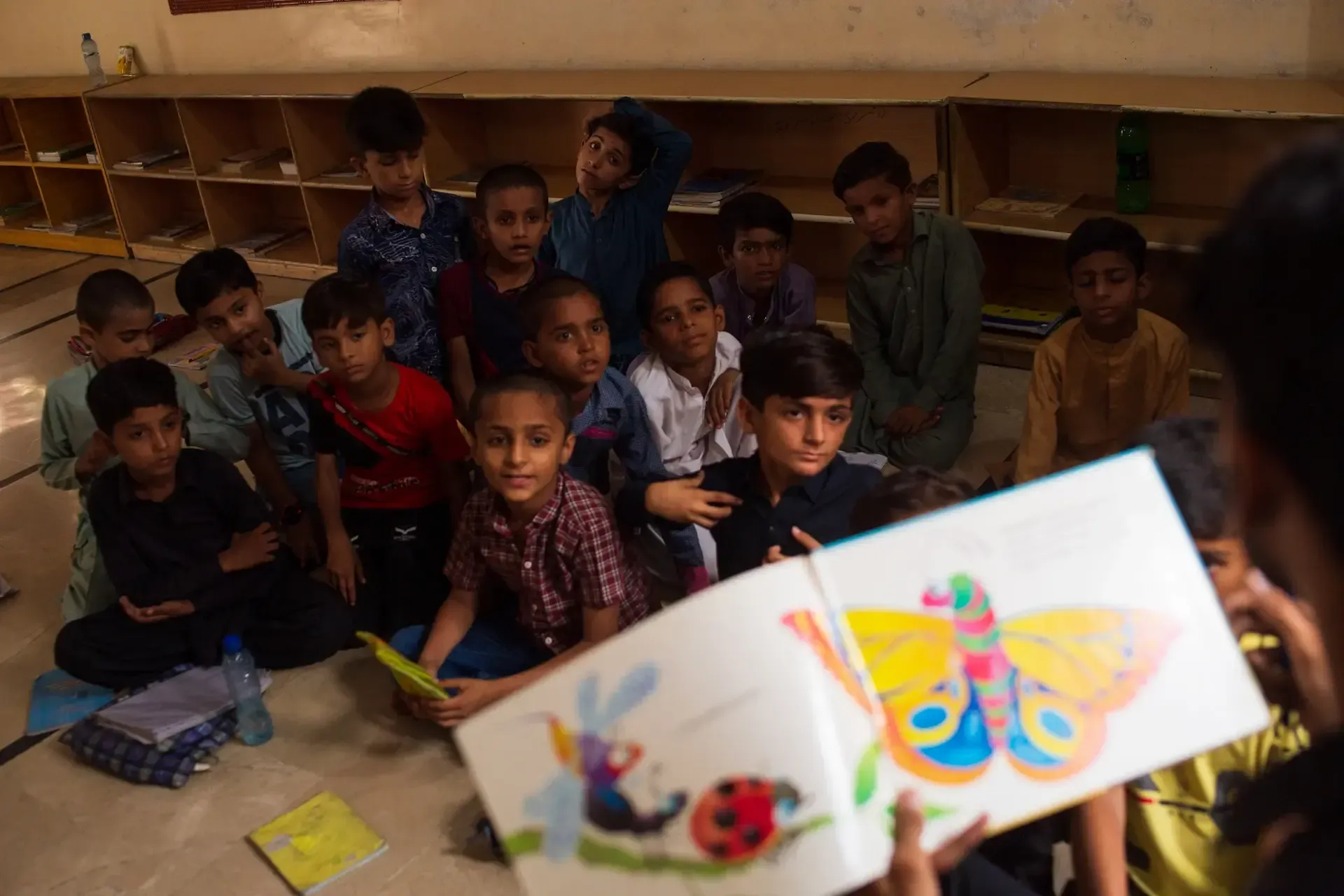 A drawing of a butterfly and students in a classroom